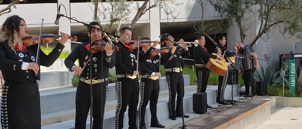 A mariachi band playing outside